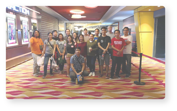 People posing in a hallway.