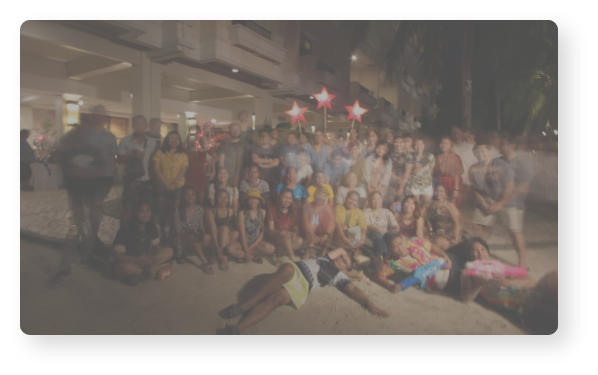 People posing outdoors at nighttime.